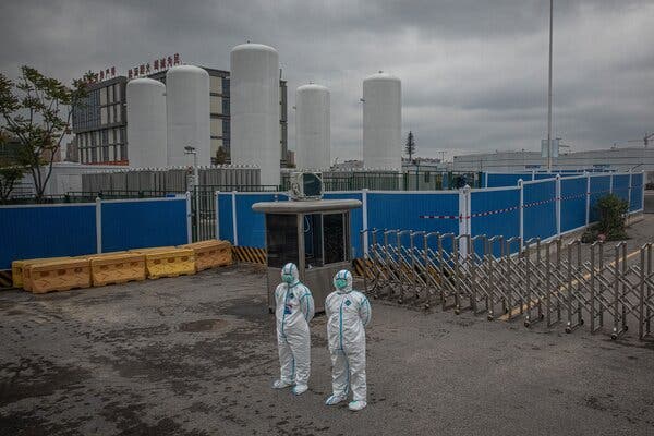 Security personnel in full protective gear stood outside the emergency field hospital Leishenshan in Wuhan, China, in April of last year.